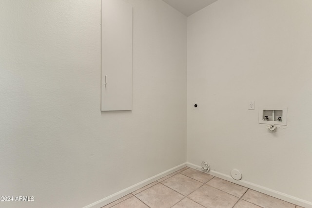 clothes washing area with electric dryer hookup, light tile patterned floors, hookup for a gas dryer, and hookup for a washing machine