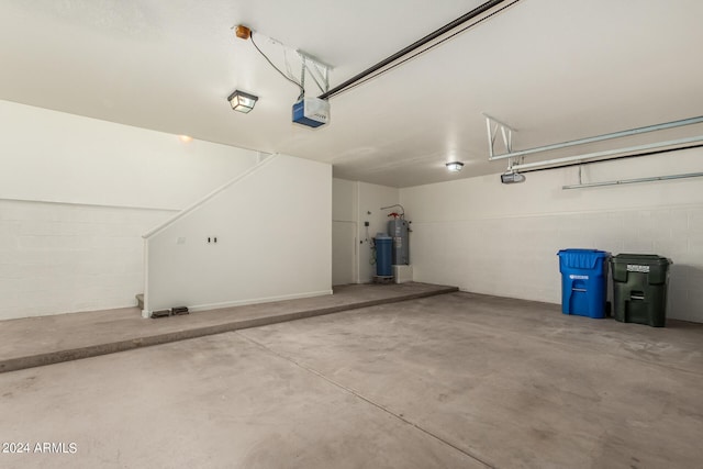 garage with a garage door opener and electric water heater