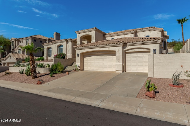 mediterranean / spanish-style house with a garage