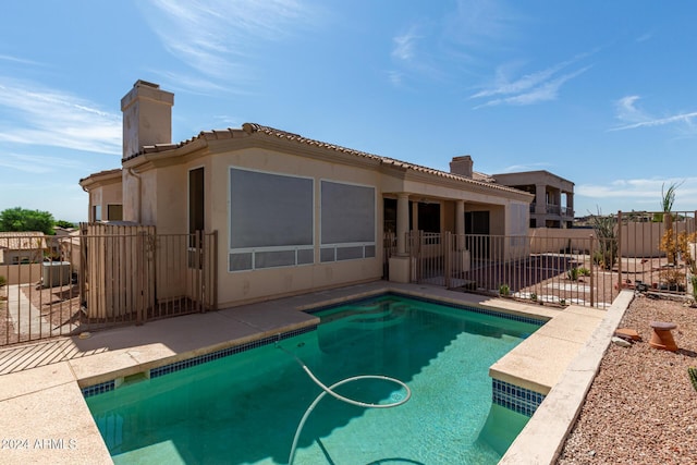 view of swimming pool with a patio area, fence, and a fenced in pool