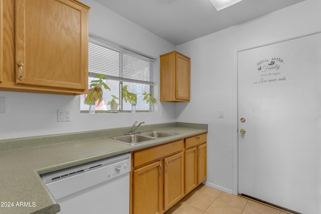 kitchen with dishwasher, light tile patterned floors, light brown cabinetry, and sink