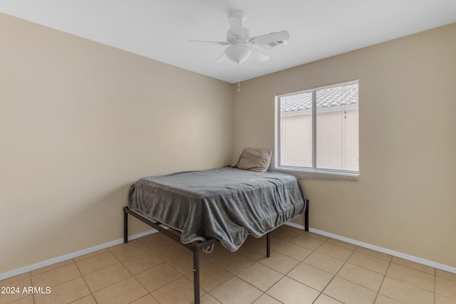 tiled bedroom featuring ceiling fan