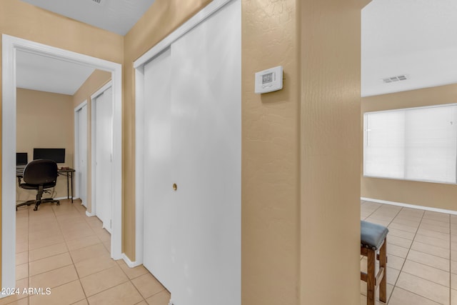 corridor with light tile patterned flooring