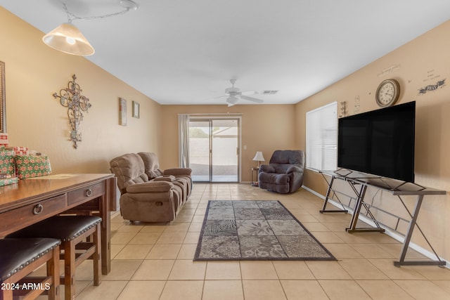 tiled living room with ceiling fan