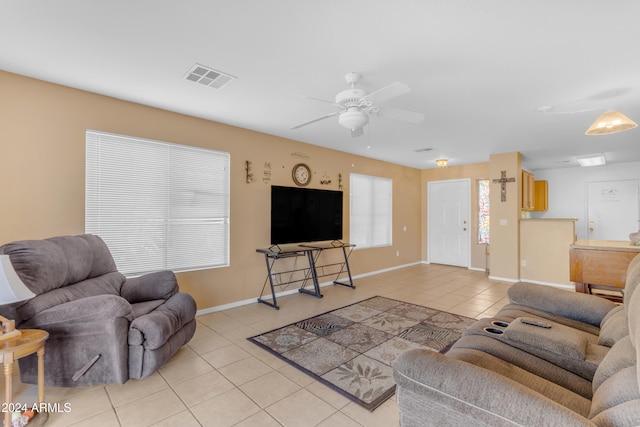 living room featuring ceiling fan, a healthy amount of sunlight, and light tile patterned floors