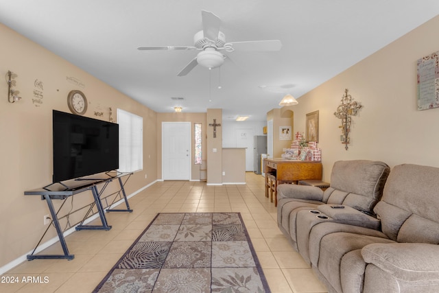 living room featuring light tile patterned floors and ceiling fan