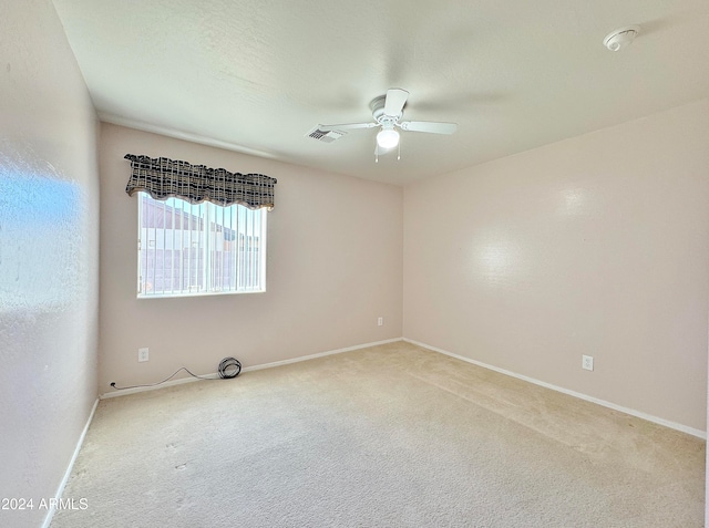 carpeted empty room with ceiling fan