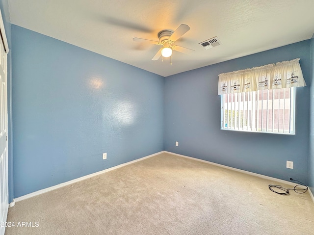 empty room featuring carpet flooring and ceiling fan