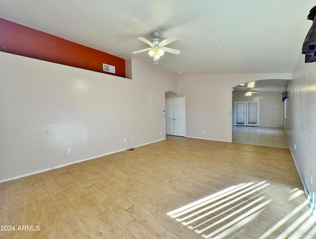 unfurnished living room featuring ceiling fan and light wood-type flooring