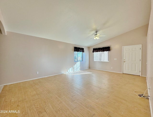 unfurnished room featuring light hardwood / wood-style flooring, vaulted ceiling, and ceiling fan