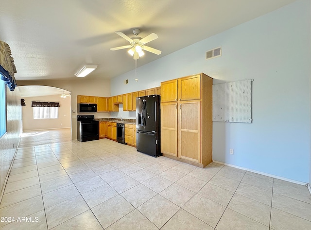 kitchen with black appliances, ceiling fan, light tile patterned floors, and high vaulted ceiling