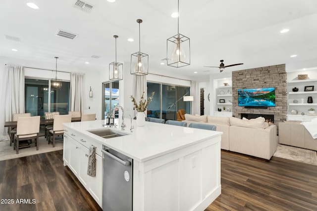 kitchen with built in features, visible vents, a sink, dark wood-type flooring, and dishwasher