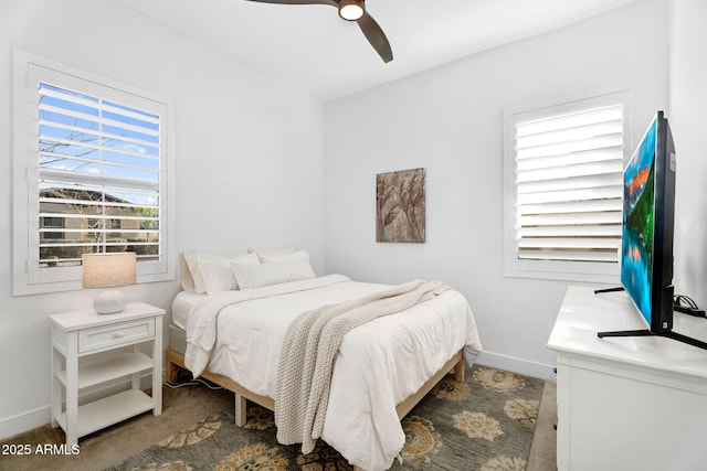 bedroom with a ceiling fan and baseboards