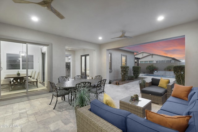 living area featuring stone tile floors, recessed lighting, and ceiling fan