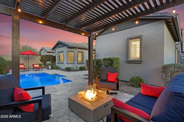 pool at dusk featuring an outdoor living space with a fire pit, an outdoor structure, area for grilling, an outdoor pool, and a patio