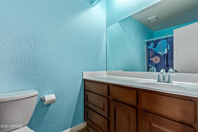 747 S Extension Rd Unit 113, Mesa, AZ 85210 - bathroom with vanity, toilet, and a textured wall
