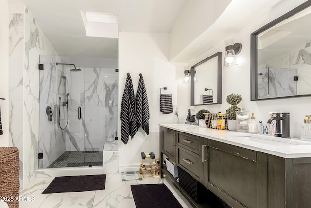 full bath featuring a sink, a marble finish shower, marble finish floor, and double vanity