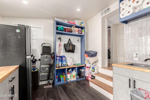 interior space featuring visible vents, recessed lighting, dark wood-style flooring, and a sink