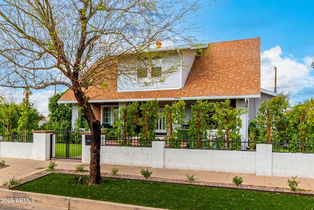 view of front facade with a fenced front yard, roof with shingles, and a gate