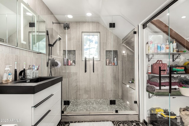 bathroom with backsplash, a shower stall, and vanity