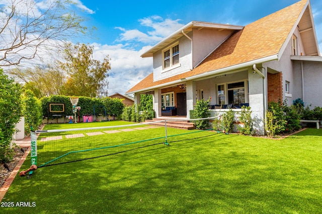 view of front of home with stucco siding and a front lawn