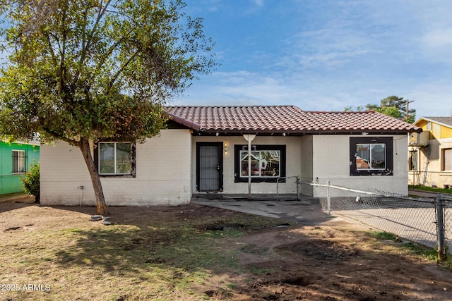 view of front of house with fence private yard and a tiled roof