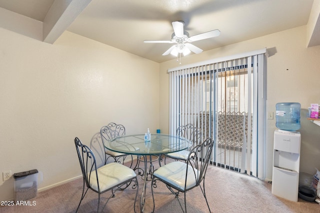 carpeted dining space featuring ceiling fan