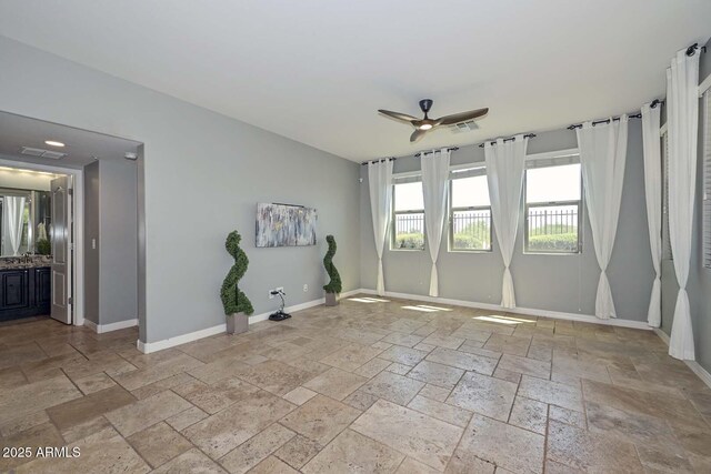 6611 S San Jacinto St, Gilbert, AZ 85298 - spare room with stone tile flooring, ceiling fan, and baseboards