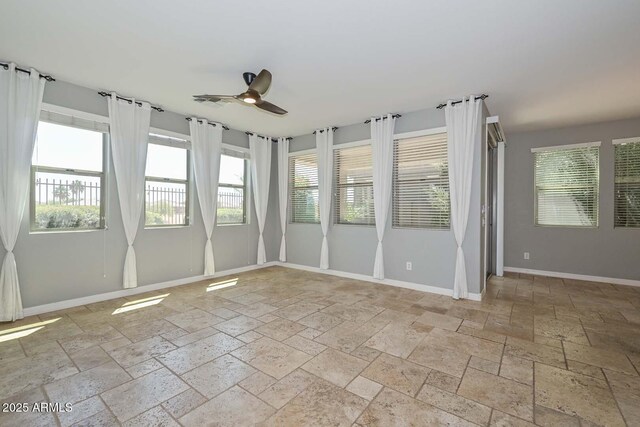 6611 S San Jacinto St, Gilbert, AZ 85298 - spare room with stone tile flooring, a ceiling fan, and baseboards