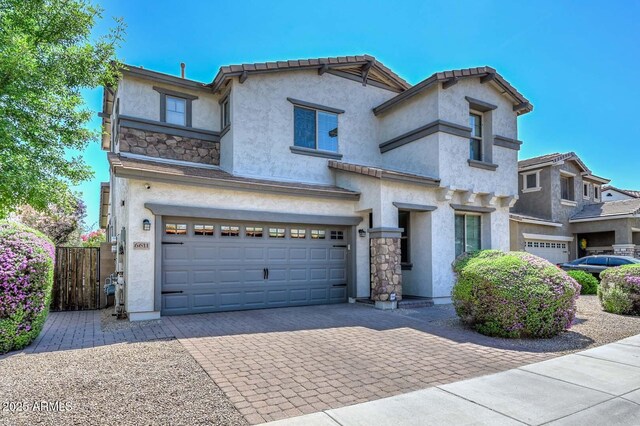 6611 S San Jacinto St, Gilbert, AZ 85298 - view of front of house featuring a garage, stucco siding, decorative driveway, and stone siding