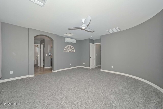 6611 S San Jacinto St, Gilbert, AZ 85298 - spare room with arched walkways, a wall mounted air conditioner, carpet floors, a ceiling fan, and baseboards