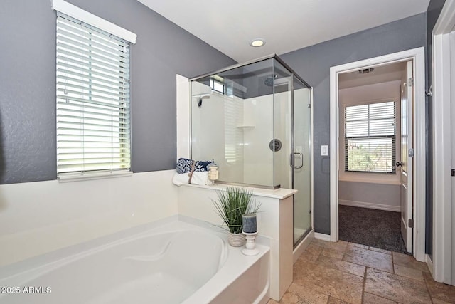 6611 S San Jacinto St, Gilbert, AZ 85298 - bathroom with stone tile floors, a stall shower, a bath, and baseboards