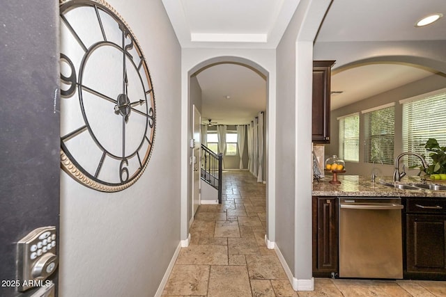 6611 S San Jacinto St, Gilbert, AZ 85298 - hall with arched walkways, stone tile flooring, baseboards, and plenty of natural light