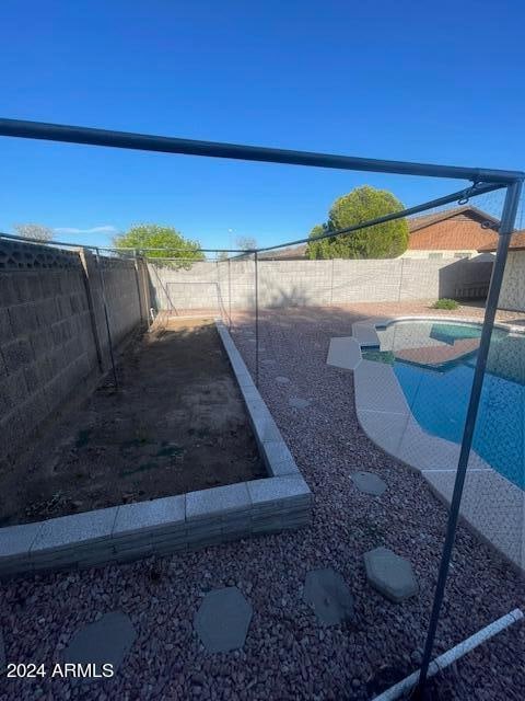 exterior space featuring a fenced in pool