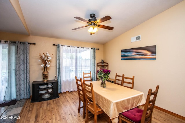 dining area featuring ceiling fan, light hardwood / wood-style floors, and vaulted ceiling