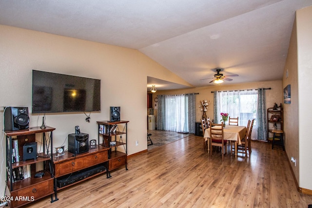 dining room featuring ceiling fan, vaulted ceiling, and wood-type flooring