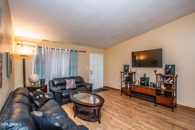 living room with light wood-type flooring and lofted ceiling