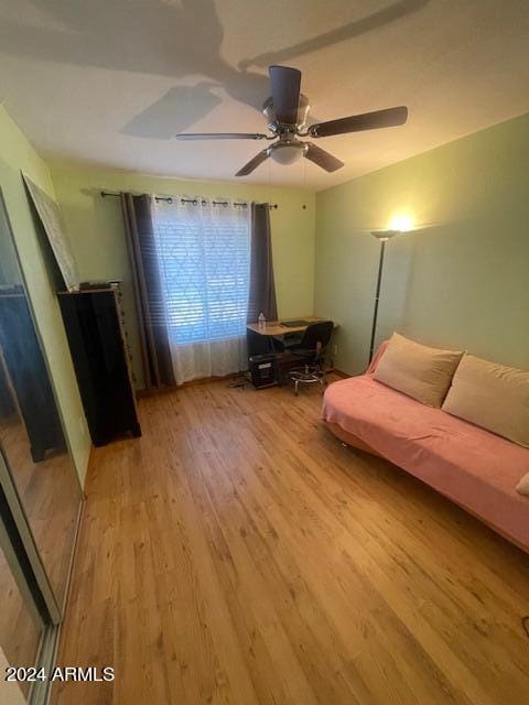 living room featuring ceiling fan and light hardwood / wood-style flooring