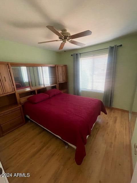 bedroom with ceiling fan and light hardwood / wood-style floors