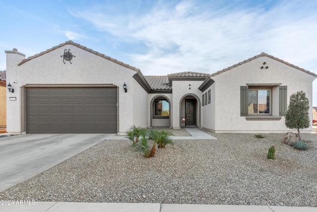 mediterranean / spanish-style house with a garage