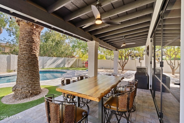 view of patio / terrace featuring ceiling fan and a fenced in pool