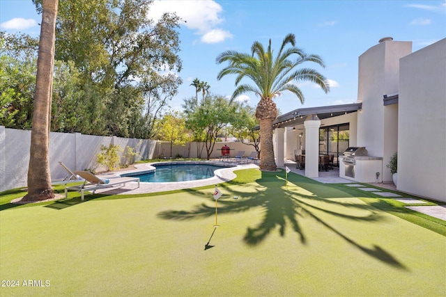 view of swimming pool featuring area for grilling, a grill, and a patio area