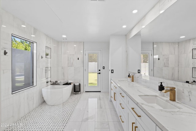 bathroom with vanity, shower with separate bathtub, and tile walls