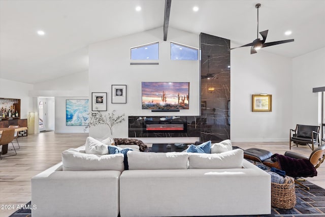 living room featuring beamed ceiling, ceiling fan, light hardwood / wood-style floors, and high vaulted ceiling