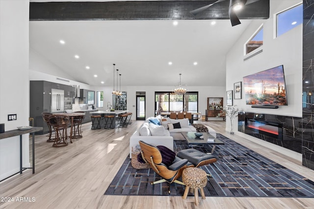 living room with hardwood / wood-style flooring, high vaulted ceiling, and ceiling fan