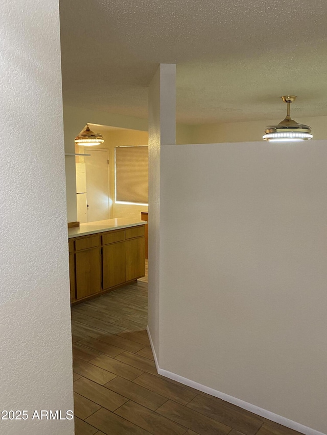 2569 W Berridge Ln Unit D-115, Phoenix, AZ 85017 - hall with baseboards, dark wood-style floors, and a textured ceiling