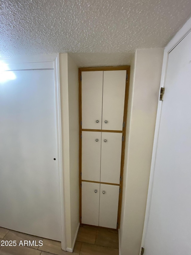 2569 W Berridge Ln Unit D-115, Phoenix, AZ 85017 - hall featuring a textured ceiling and light tile patterned floors