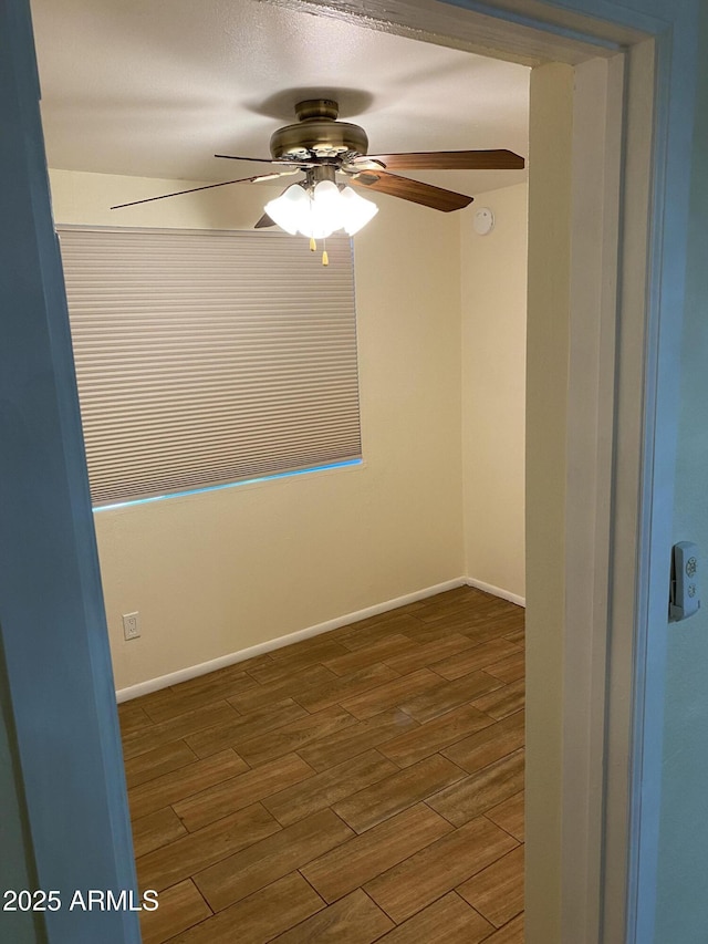 2569 W Berridge Ln Unit D-115, Phoenix, AZ 85017 - empty room with ceiling fan, baseboards, and wood finished floors