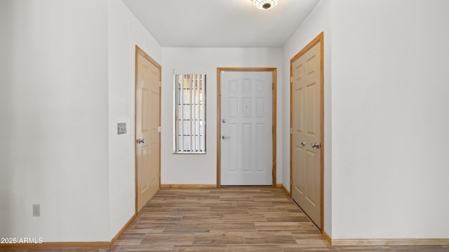 corridor with light hardwood / wood-style floors