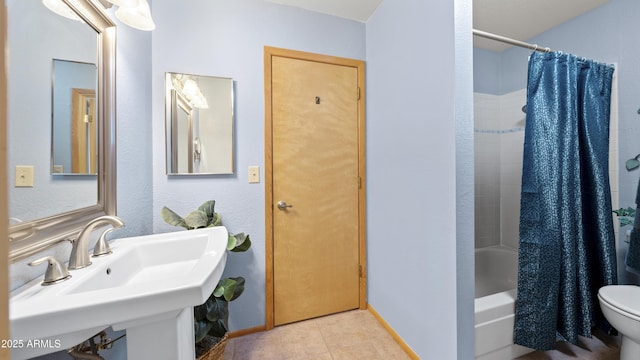 full bathroom featuring tile patterned flooring, toilet, sink, and shower / tub combo with curtain